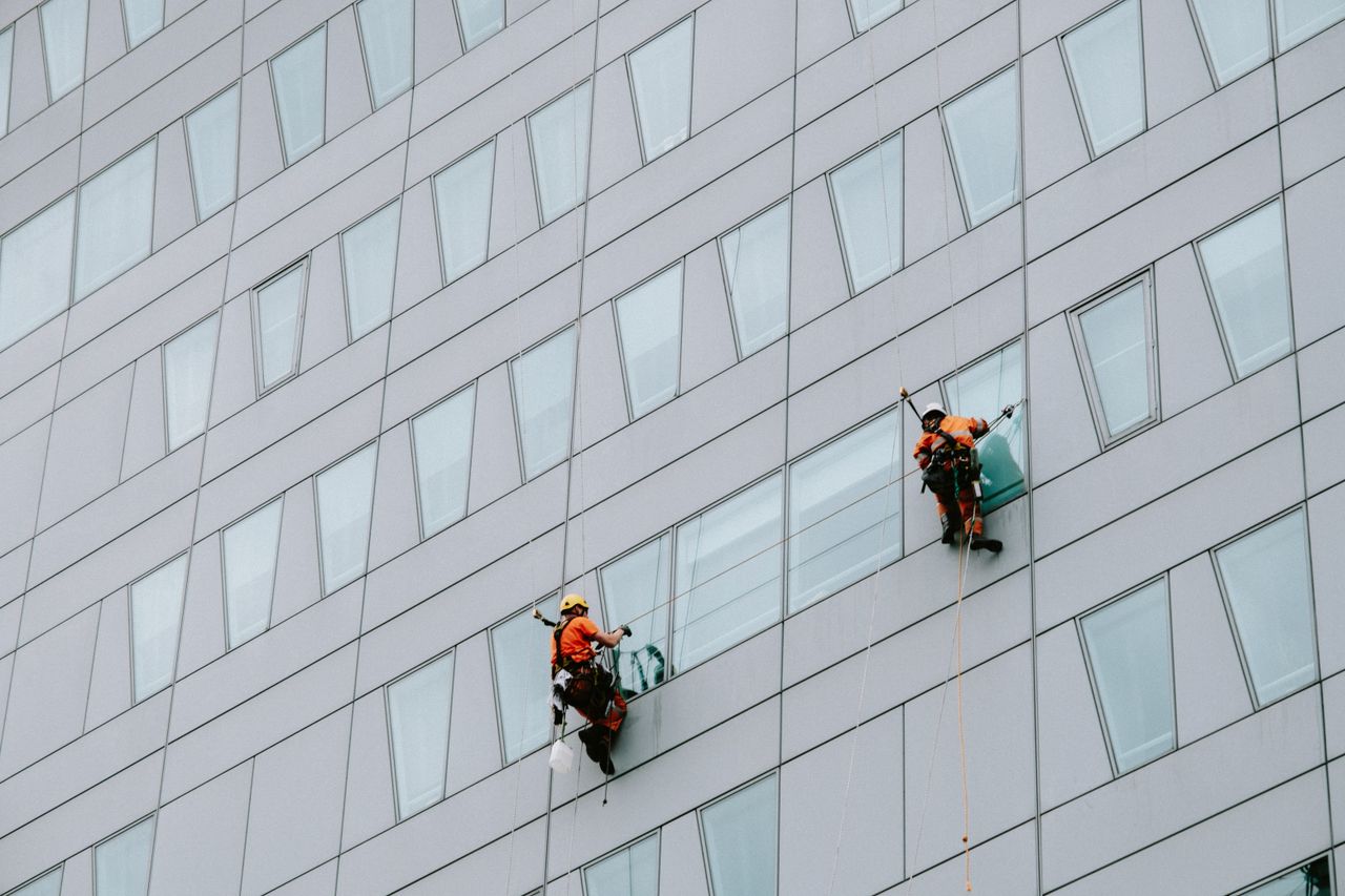 gallery-02 Window washers in safety equipment cleaning the exterior of a skyscraper.